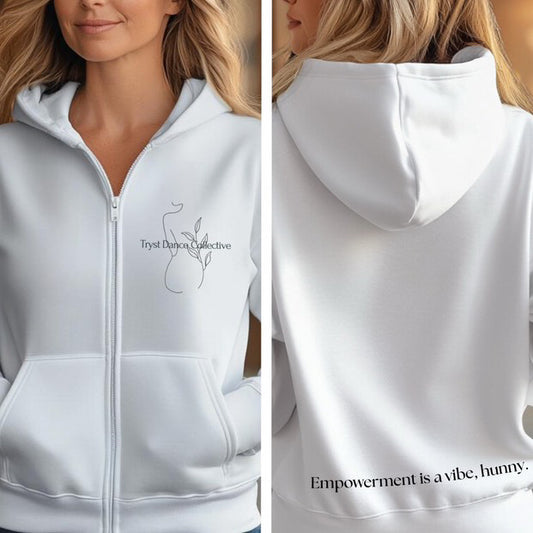 A black zip-up hoodie with the limited edition Tryst Dance Collective logo on the front and the empowering statement 'Dance like EVERYONE is watching' on the back.